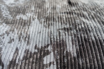 Closeup of gray corduroy fabric with abstract print