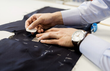male tailor with chalk in hand