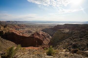 Vast canyon landscape under bright sky.