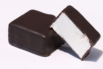 Chocolate candies with filling on a light background. milk chocolate.