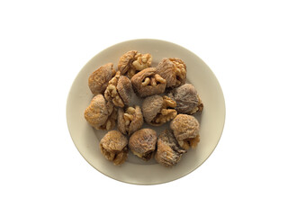 Dry figs with walnuts on plate on a white background