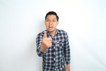 angry asian man pointing finger to camera with crazy face wear casual shirt isolated on white