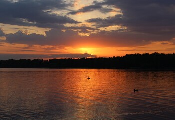 Orange sunset over the lake, beautiful abstract nature background, landscape, bright sky, spring warm evening, bright colors of spring, water, reflection, sun rays, fiery sunset, inspiration, horizon