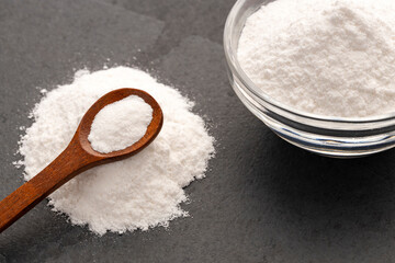 Baking soda powder in spoon and bowl - Healthy food.