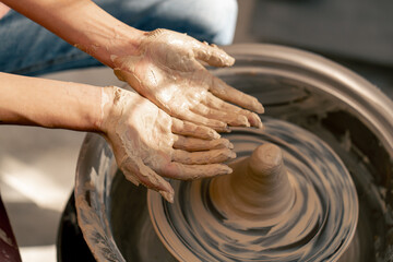 close up the clay modeling studio young girl hands giving shape to clay on a potter's wheel applied art clayware old craftsmanship