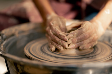 close up the clay modeling studio young girl hands giving shape to clay on a potter's wheel applied art clayware old craftsmanship teacher helps
