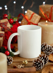 White coffee mug near red knitted sweater and Christmas decor and lights, winter mockup