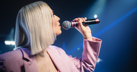 Lead Singer of a Pop Band Performing a Hit Song on Stage, Inspiring a Large Audience of Music...