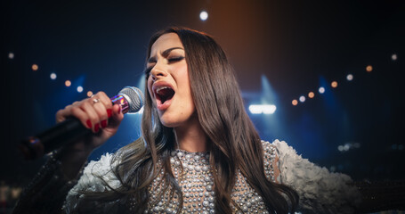 Close Up Portrait of a Pop Band Lead Singer Performing a Hit Song on Stage, Inspiring a Large...
