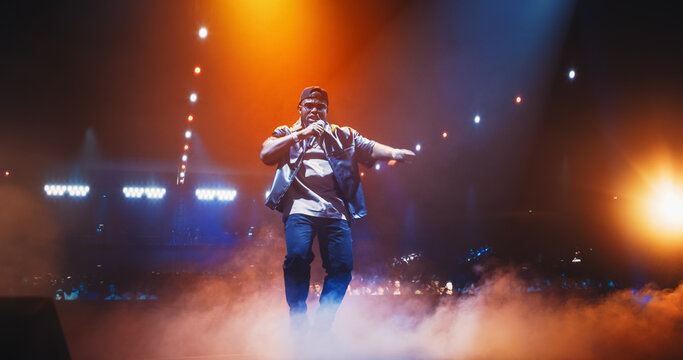 Young African Hip Hop Musician Delivers an Unforgettable Concert. Black Rapper Dancing in Smoke on Stage, Charismatic Presence and Gangster Lyrics Captivate and Excite the Crowd of Music Goers