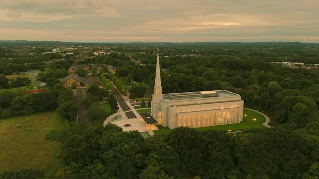 Chorley, Lancashire, UK, July 21, 2024; aerial high level orbit clip at sunset of the Preston England Temple Church of Latter Day Saints, Chorley Lancashire England