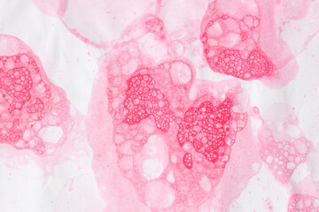 Pink watercolor stains on white paper. Abstract background and texture.