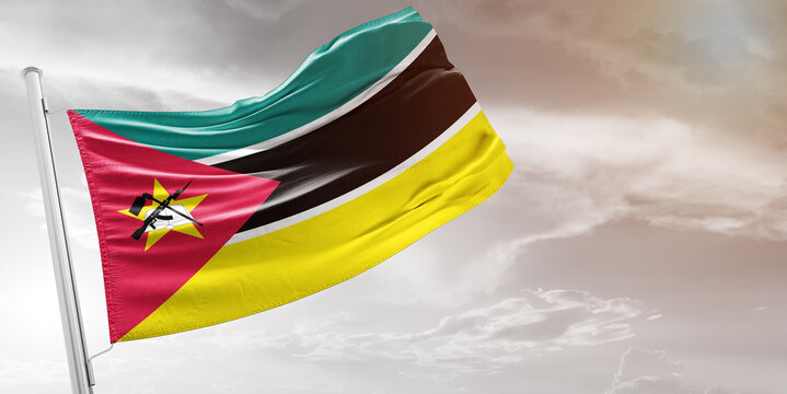 Mozambique national flag cloth fabric waving on beautiful grey Background.