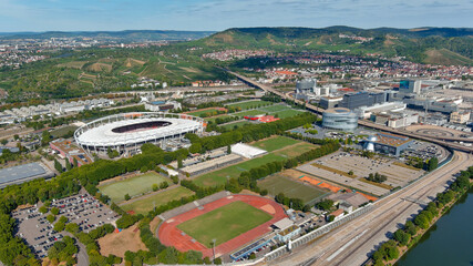 Stuttgart’s sports stadium surrounded by green hills and vineyards, offering a picturesque view...