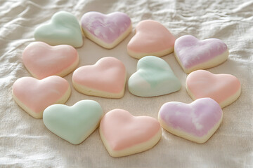 Obraz premium Charming Array of Heart-Shaped Pastel Cookies on a Soft Tablecloth