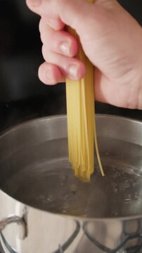 Throw Spaghetti Gluten Free Pasta Into A Pot Of Boiling Water