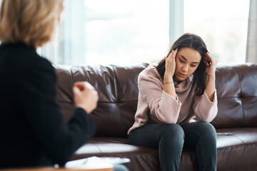 Woman, therapist and depression for counselling, help and conversation for support on couch....