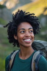 Fototapeta premium A woman with a backpack is smiling at the camera