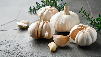 Fresh garlic and cloves on dark kitchen table. Farm vegetable harvest, raw eco vegetarian food