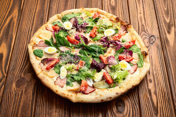 Italian pizza caesar with eggs salad chicken tomatoes and mozzarella photography. top view