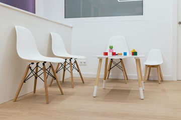 Modern waiting room designed for children with toys on table