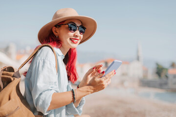 Tourist using smartphone while visiting european city on sunny summer day