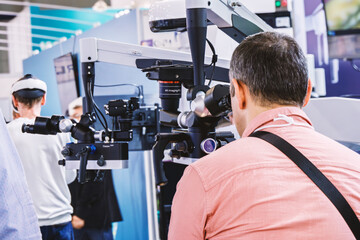 Man looking into a dental microscope