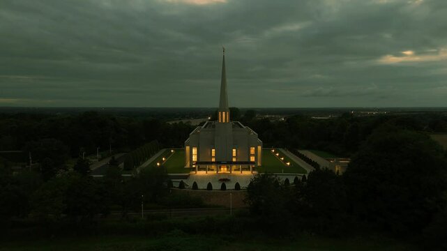 Chorley, Lancashire, UK, July 21, 2024; aerial reverse reveal clip at sunset of the Preston England Temple Church of Latter Day Saints, Chorley Lancashire England