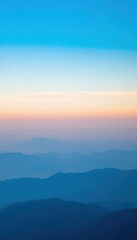 Fototapeta premium view of a mountain range with a blue sky sparse mountains on the horizon