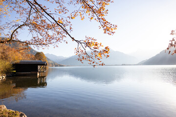 Mountain background with Zeller Lake and small boot house. Zell am See, Austria