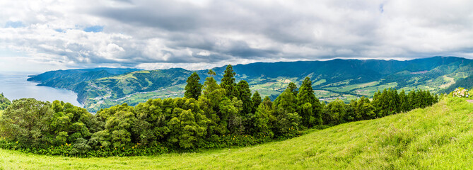A panorama view looking down from the Sunset Viewpoint over the town of Povoacao on the island of Sao Miguel in the Azores in summertime