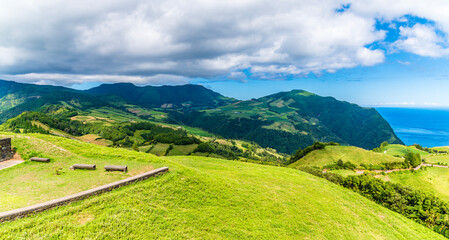 Fototapeta premium A view eastward from the Sunset Viewpoint above the town of Povoacao on the island of Sao Miguel in the Azores in summertime