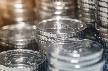Selective focus of pile silver coins under light. Background economic trends for business, financial.