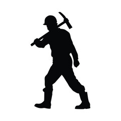 Obraz premium A man is holding a pickaxe and walking on a rock. He is wearing a helmet
