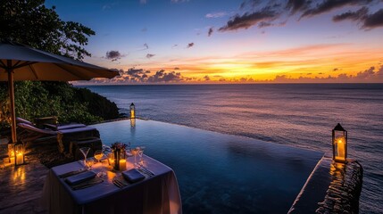 Romantic dinner for two by the infinity pool overlooking the ocean at sunset.