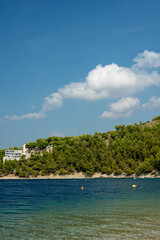 Sunny beaches of Stanići, Croatia, with clear azure waters and sandy shores, capturing perfect coastal beauty.