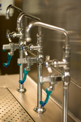 Close up image of the water faucets in a restaurant kitchen