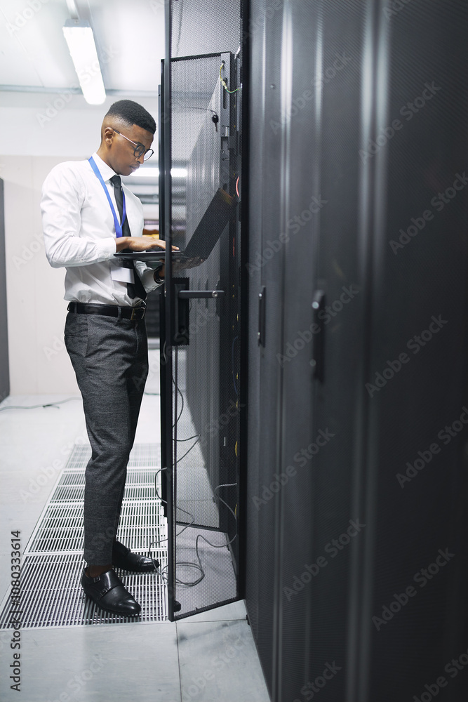 Poster black man, engineer and server room with laptop at data center for hardware fault or network repair.