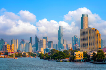 Fototapeta premium River view on Chao Phraya with skyscraper evening sunset time In Bangkok, Thailand.