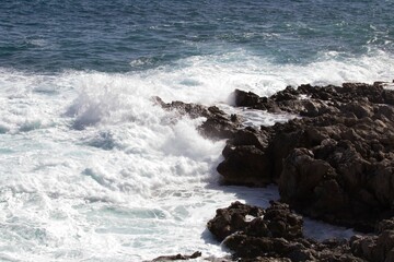 evocative image of a rough sea hitting the rocks in Sicily