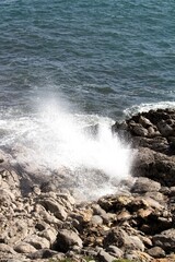 evocative image of a rough sea hitting the rocks in Sicily