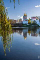 Fototapeta premium View of the Theotokos-Smolensky Novodevichy Convent of the 16th century in Moscow on an autumn sunny day from the side of Novodevichy Pond