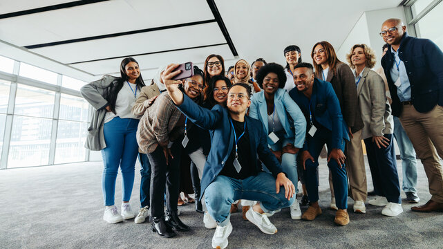 Diverse business team taking group selfie at a work conference