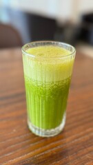 Green healthy juice on a table in a cafe