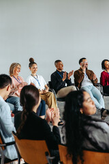 Corporate team participating in a workshop, diverse group applauding and showcasing collaboration...