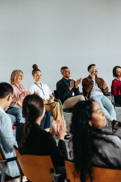 Corporate team participating in a workshop, diverse group applauding and showcasing collaboration and engagement