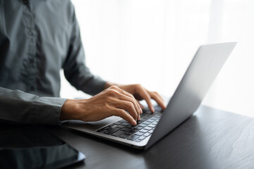 Business man working with laptop Hands typing  keyboard. Professional investor working new start up project. business planning in office. Technology business..