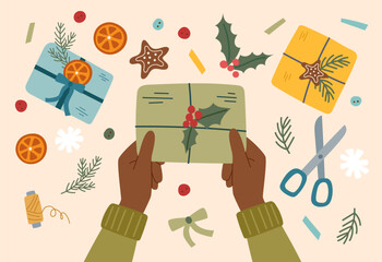 Sustainable Christmas concept. Eco friendly packaging of Christmas gift. Hands holding a wrapped Christmas present.