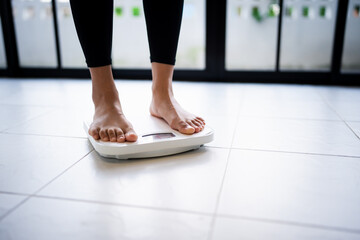 Lose weight. Fat diet and scale feet standing on electronic scales for weight control. Measurement...
