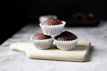 Chocolate muffins with sugar. on a gray background.dessert